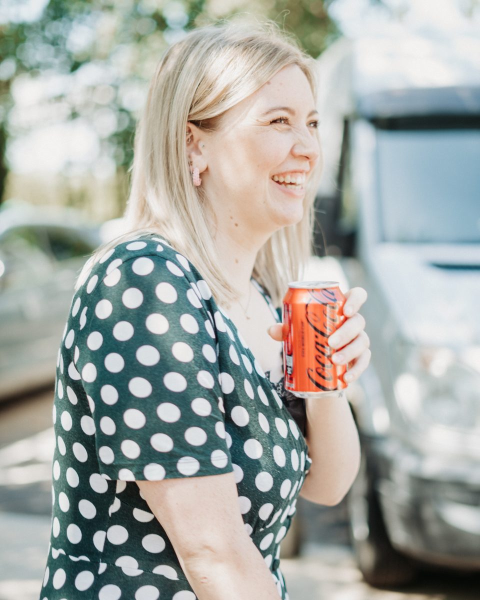 A woman laughing at a summer church gathering