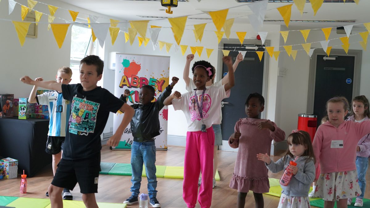 Children dancing and playing games at Grow Kids