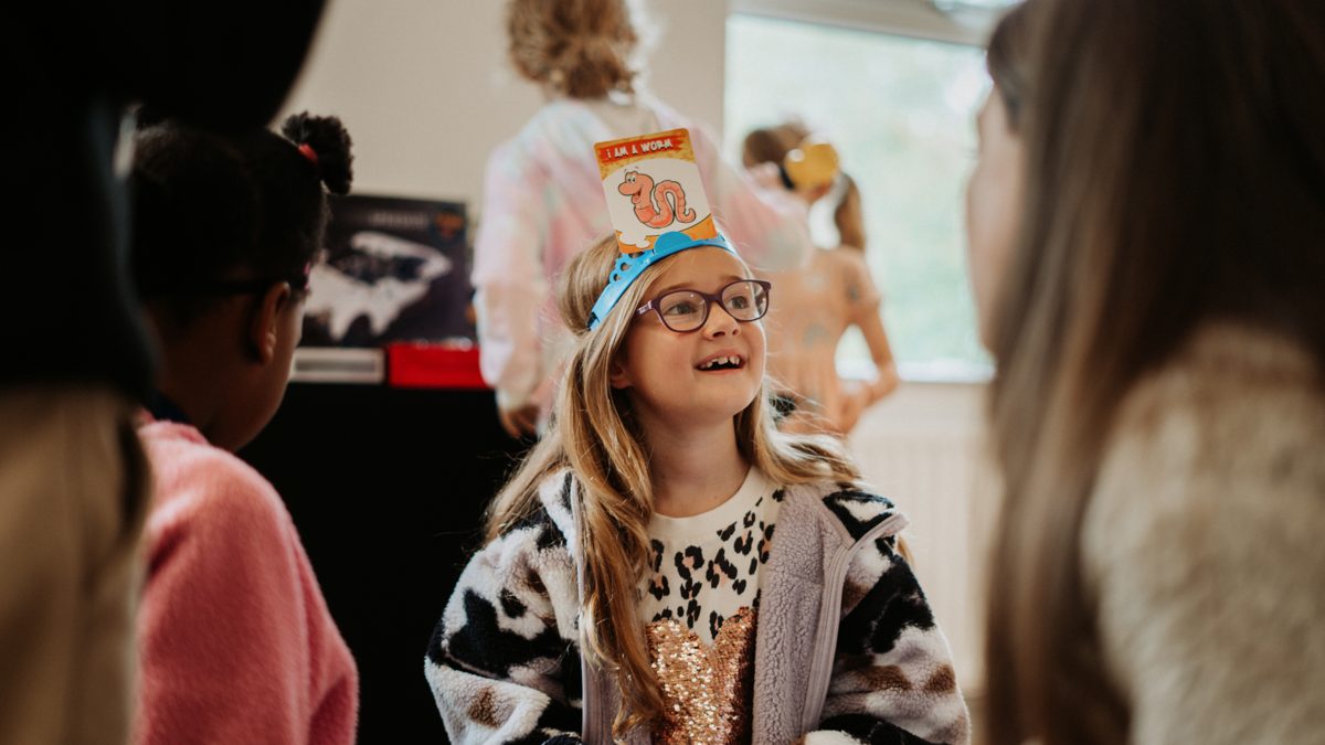 A girl smiling during a Grow Kids session